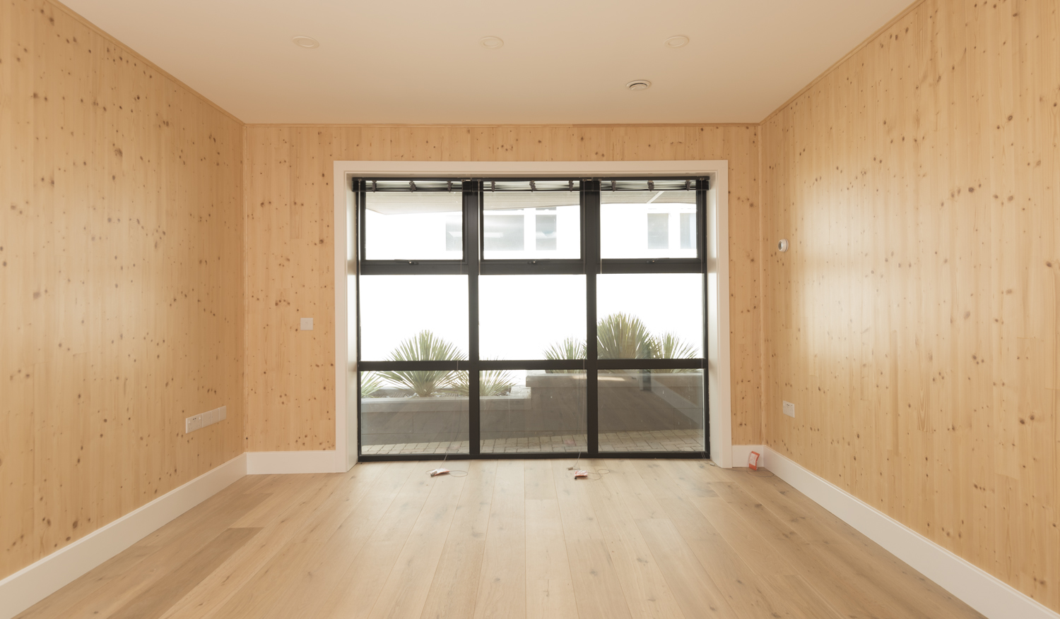 Inside of a modern new build house viewing outside into the garden