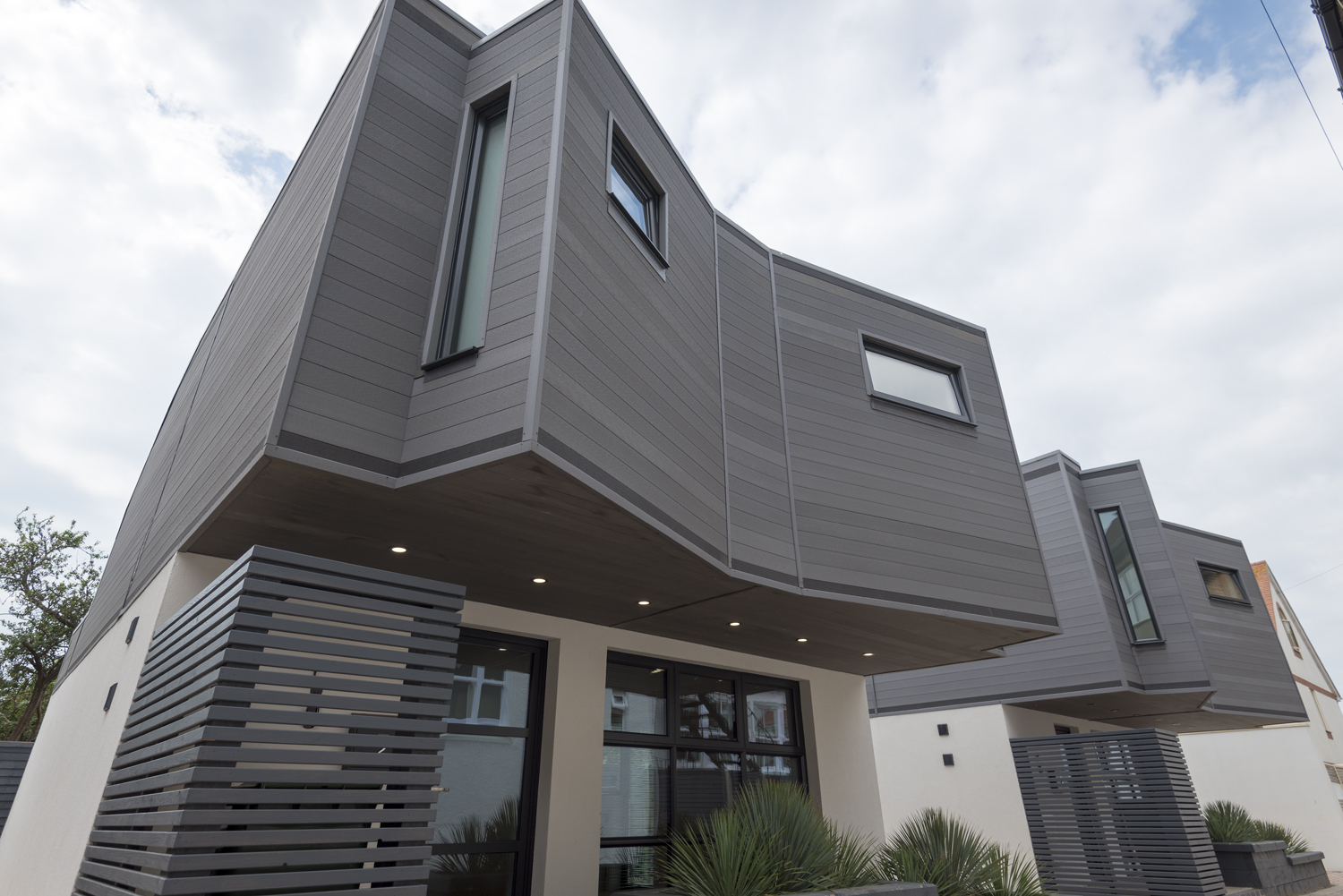 Ouside view of a modern house looking up towards the upper floor