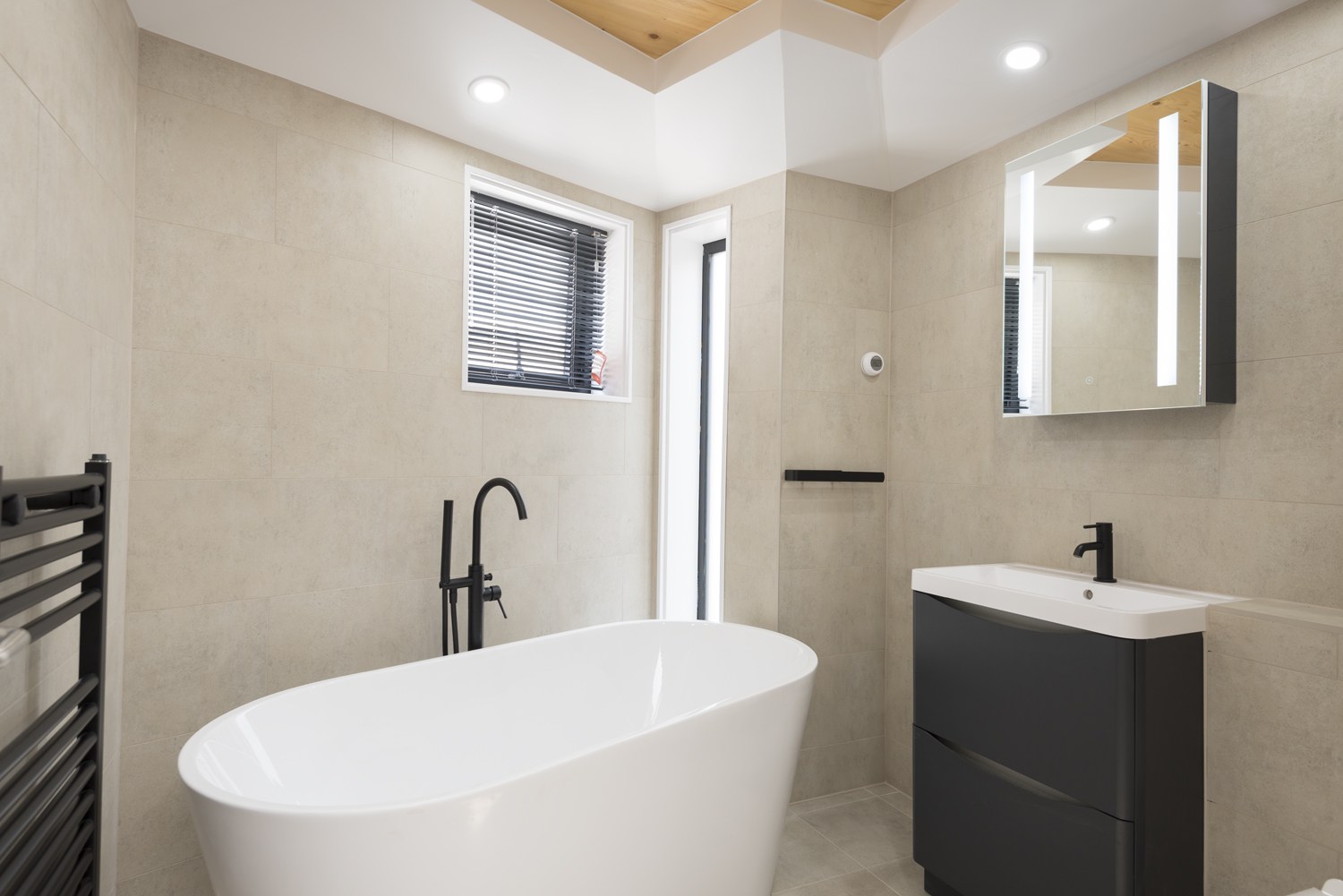 A Modern new build bathroom with a bath tub and a sink