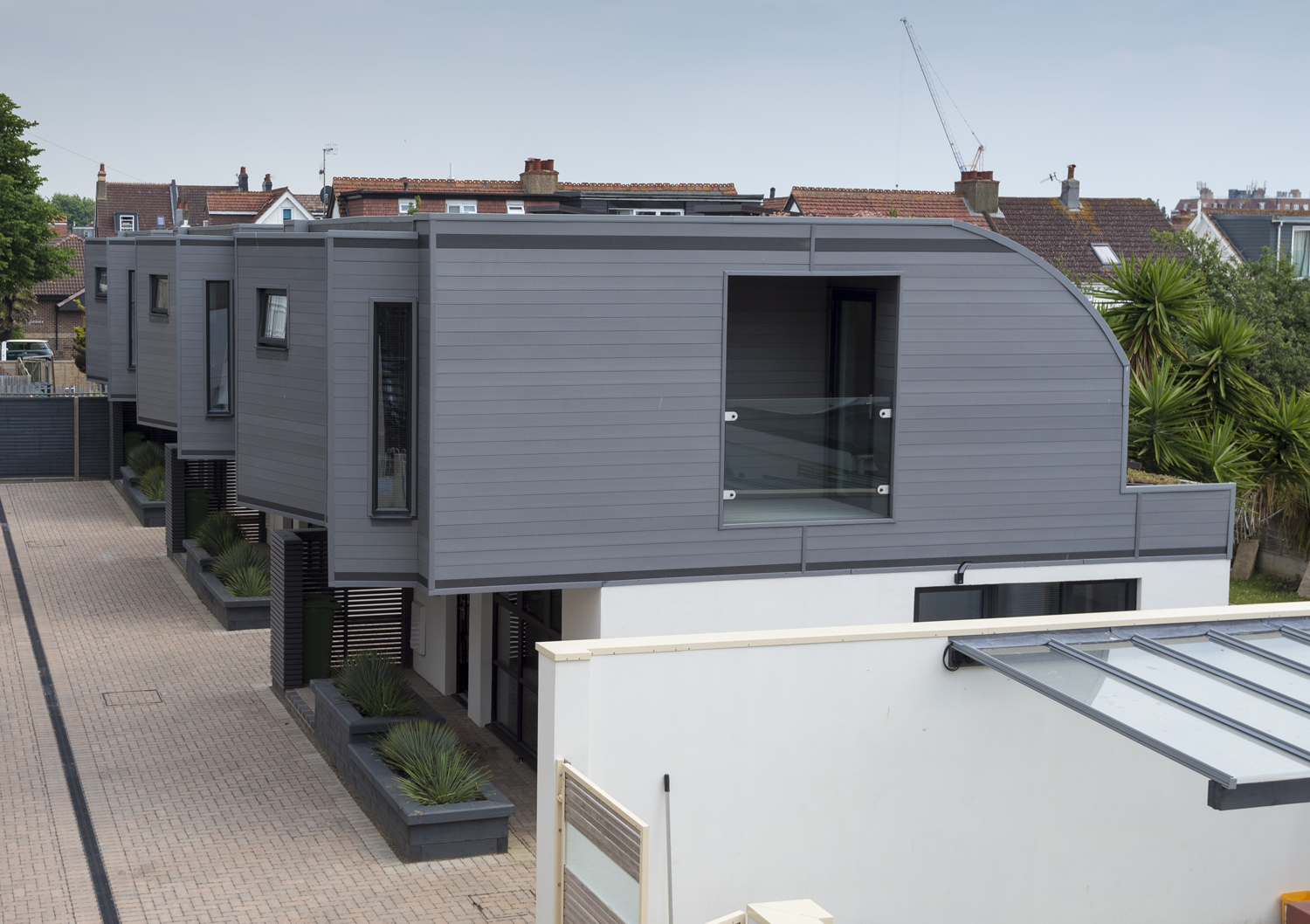 High view of a row of modern housing showing the top floors next to each other