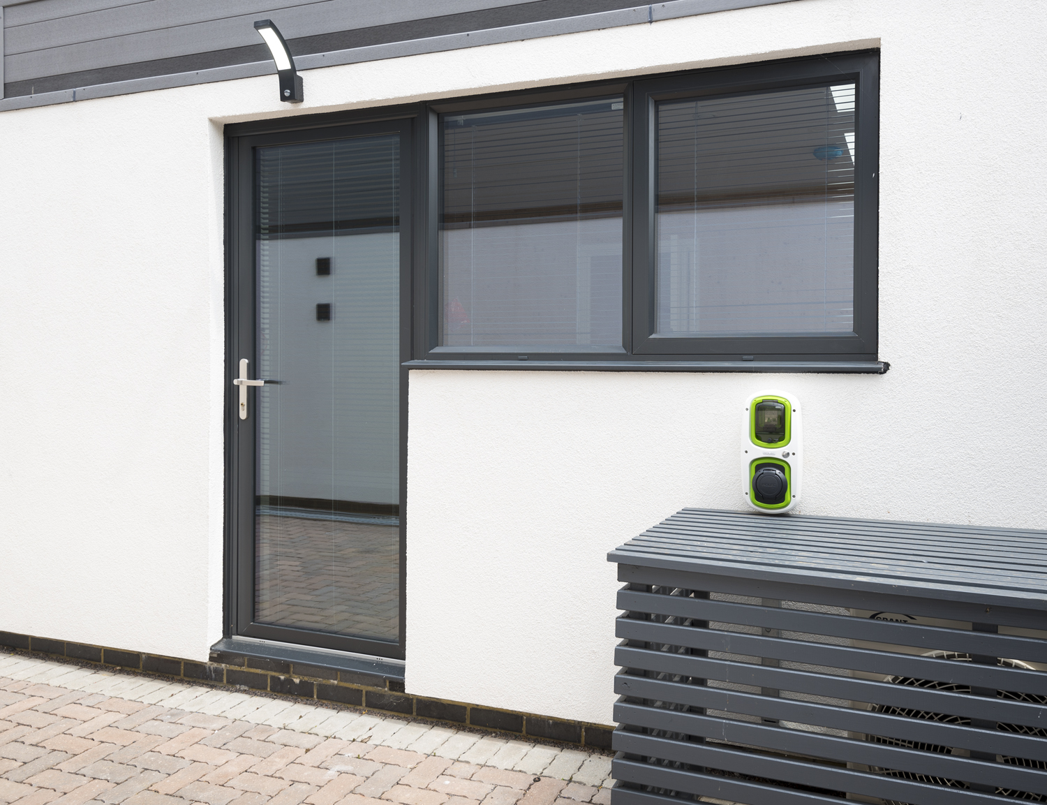 Side view of a back door with a electric car charger